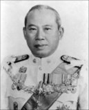 Field Marshal Thanom Kittikachorn (August 11, 1911 - June 16, 2004) was a military dictator of Thailand. A staunch anti-Communist, Thanom oversaw a decade of military rule in Thailand from 1963 to 1973, until public protests which exploded into violence forced him to step down. His return from exile in 1976 sparked protests which led to a massacre of demonstrators, followed by a military coup.<br/><br/>

In October 1976, Thanom returned to Thailand as a novice monk at Wat Bowonniwet. His return triggered student protests which took place on the campus of Thammasat University. The far right, aided by government security forces, stormed the campus and massacred protesters on 6 October 1976. That evening, the military again seized power from the elected civilian government.<br/><br/>

Thanom soon left the monkhood but never took a role in politics again. Later in his life, he made an effort to rehabilitate his tarnished image and recover properties that had been seized when he was overthrown.<br/><br/>

In March 1999, Thanom was nominated to become a member of the honorary Royal Guard by Prime Minister Chuan Leekpai, which was a highly controversial act. Thanom turned down the appointment.<br/><br/>

Thanom died at the age of 92 on 16 June 2004 in Bangkok General Hospital, after suffering a stroke and a heart attack in January 2004. His medical expenses were paid by King Bhumibol Adulyadej. His cremation was held on 25 February 2007 at Wat Debsirin. Queen Sirikit presided over the cremation ceremony, lighting the royal flame on behalf of King Bhumibol. Princess Chulabhorn also presided.